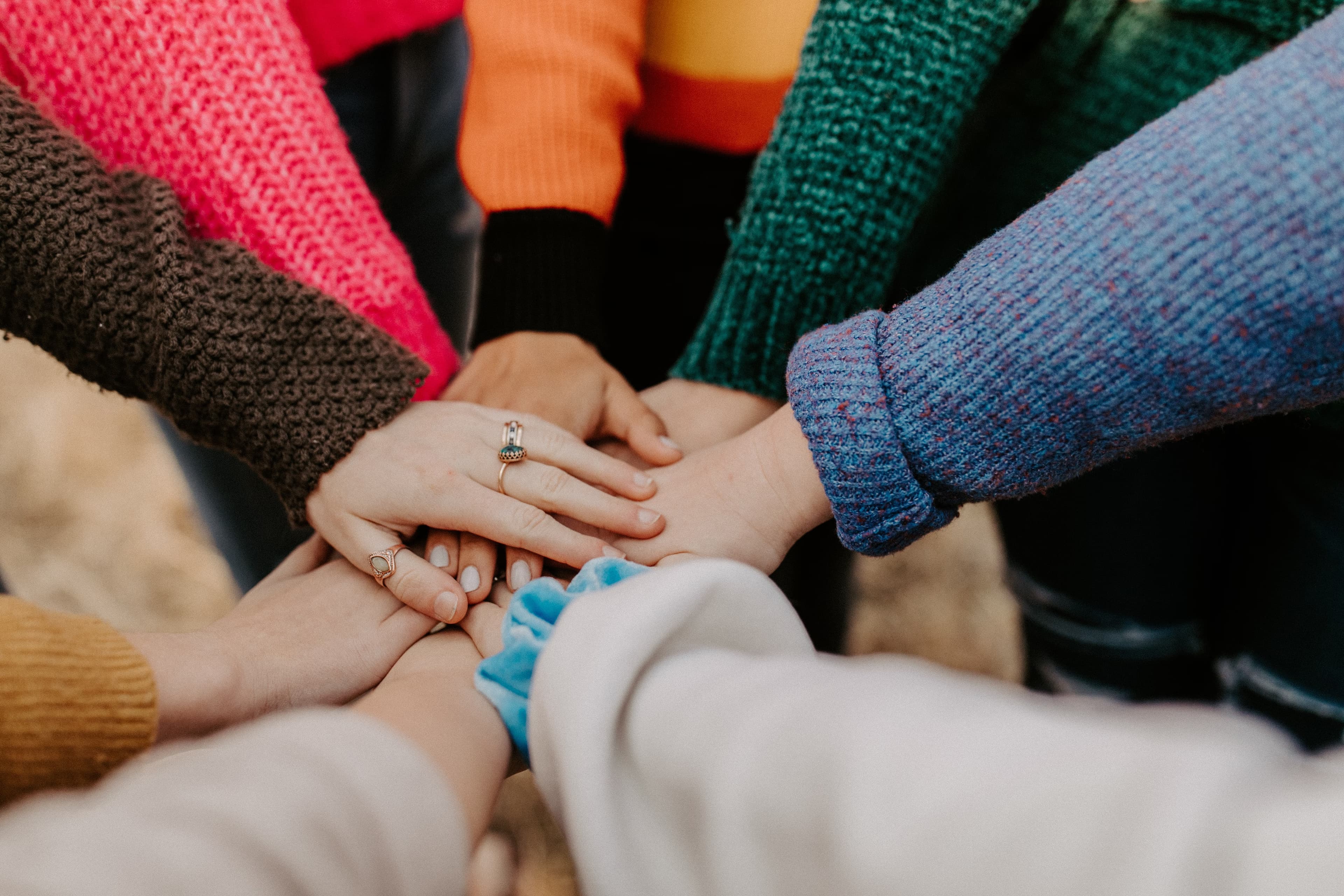 A lot of people holding hands in a circle
