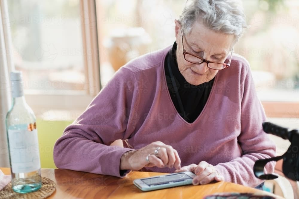 An old lady using a phone